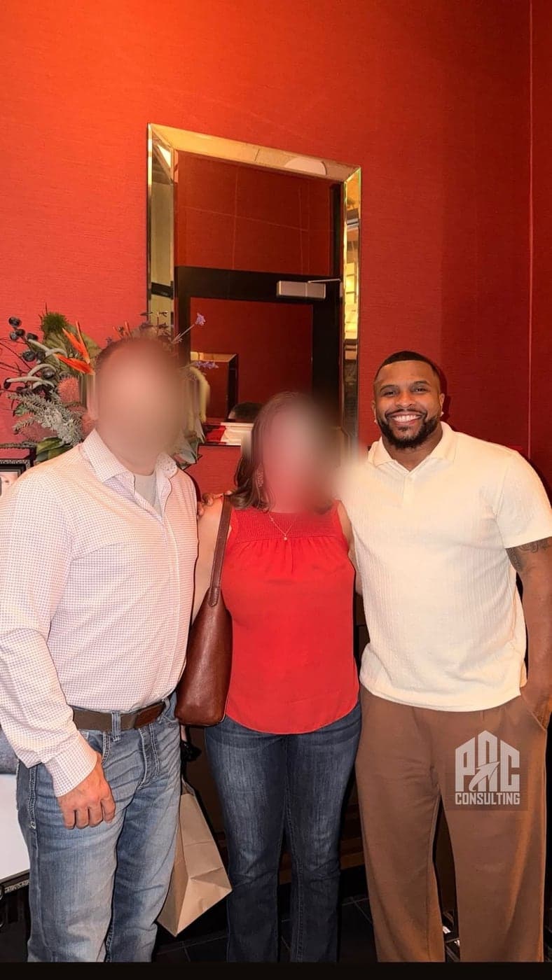 Phillip Crawford with a business-owner couple he has worked with, their faces blurred for confidentiality